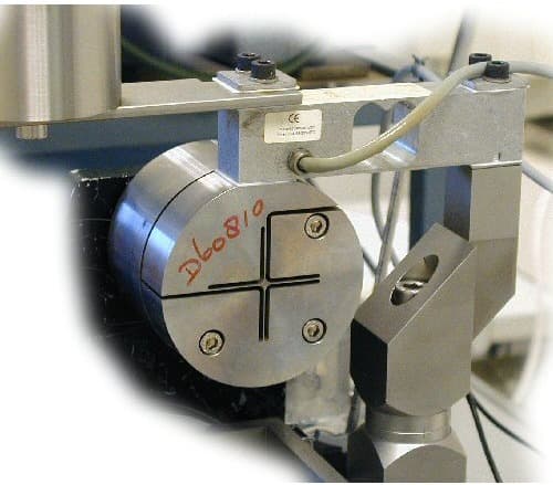 A laboratory test rig for a flexure cross-hinge, with the hinge mounted between measurement fixtures